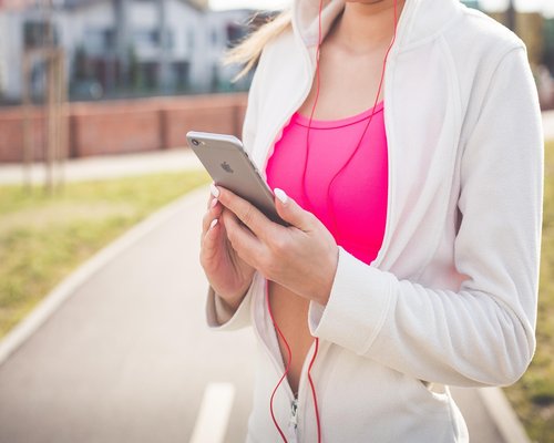 Happy senior woman jogging in a park wearing sportswear