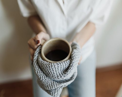 A warm towel and a cup of tea representing relaxation